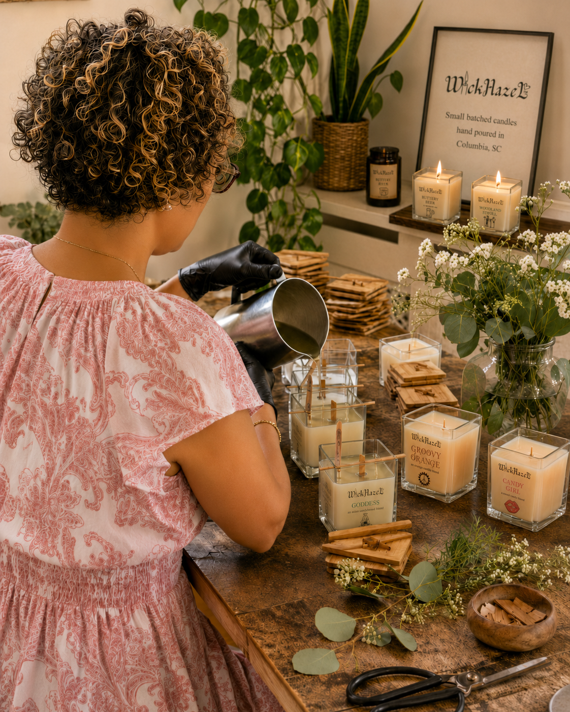 Woman hand-pouring WickHazeL candles in a cozy candle-making workspace